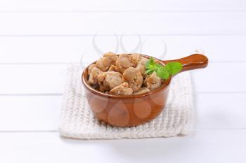 saucepan of soy meat cubes on white table mat