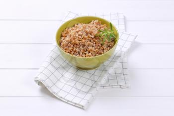 bowl of cooked buckwheat on checkered dishtowel