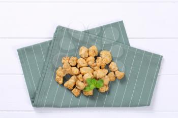 pile of soy meat cubes on grey place mat