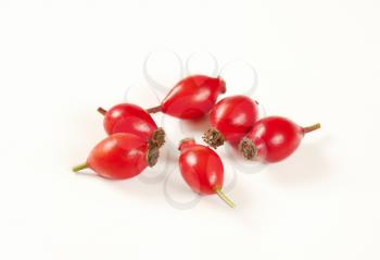 group of rose hips on white background
