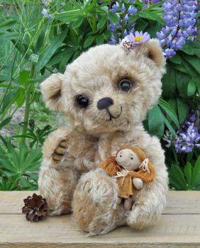 Teddy-bear Lucky with a rag doll on the board against a background of flowers. Handmade, the sewed toy