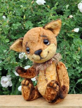 Handmade, sewed plush toy: Ron fox cub on a board among flowers