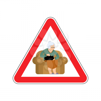 Attention grandmother. Caution old woman and cat. Red triangle road sign
