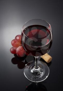 wine glass and grapes on black background