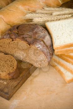 bakery products and grain on wood background