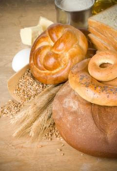 bread and grain on wood background