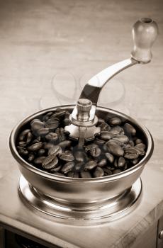 coffee beans and grinder on wood background