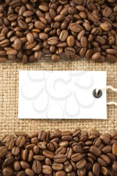 coffee beans and paper price tag on sack burlap texture