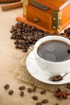 cup of coffee and beans on wood background