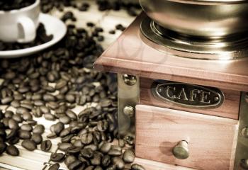 coffee beans, cup and grinder on sacking