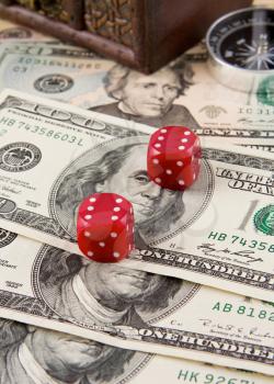 red dices and compass on dollars