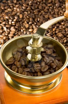 coffee grinder and roasted beans as background