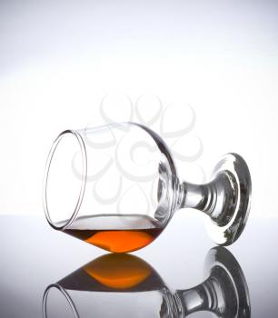 cognac glass with brandy on white