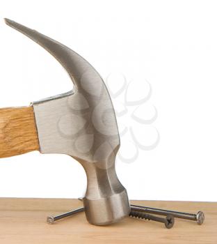 hammer and nail on wood isolated at white background