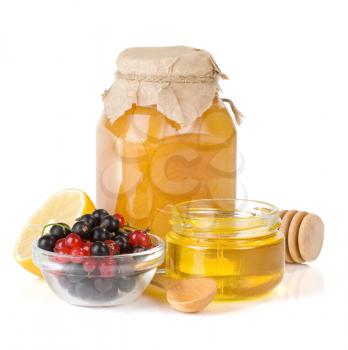 glass jar full of honey, lemon and berry isolated on white background