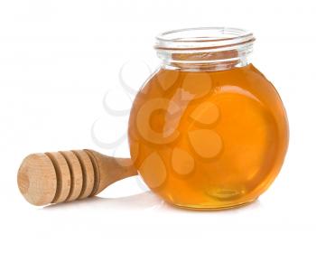 glass pot full of honey and stick  isolated on white background