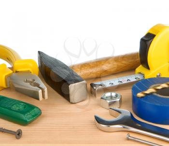 tools and instruments isolated at white on wooden texture