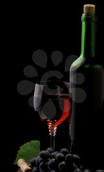 red wine in glass and bottle isolated on black background