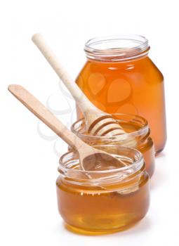 glass pot full of honey isolated on white background
