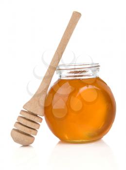 glass pot full of honey and stick isolated on white background