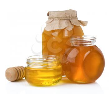 glass jar and pot of honey with stick isolated on white background