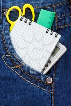 notebook and pencil in jeans packet