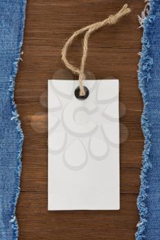 blue jean and price tag on wood texture background