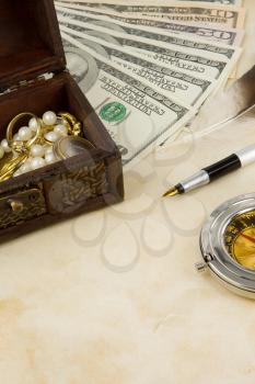 dollars, compass, box and euro coins on texture