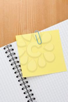 note paper and checked pad on wood background