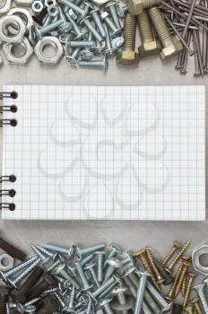 metal construction  hardware tool and blank notebook