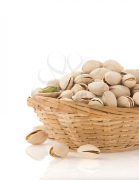 pistachios in bowl isolated on white background