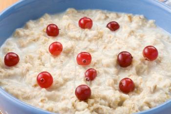 bowl of oatmeal and milk on wood background