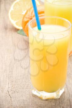 fresh fruits orange juice in glass on wood board background
