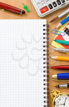 back to school concept and checked notebook on wood background