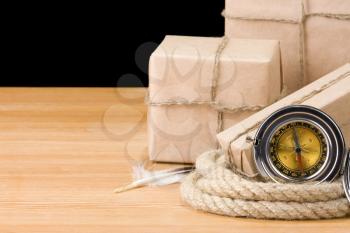 parcel wrapped box and rope on wood isolated over black background