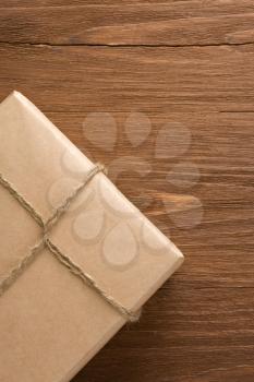 parcel wrapped packaged box on wood background
