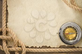 ropes and compass at old vintage ancient paper background texture