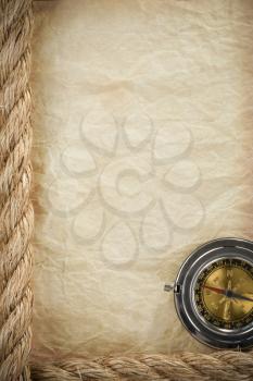 ropes and compass at parchment old paper background texture