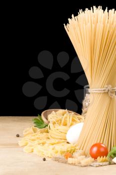 raw pasta and food ingredient isolated on black background