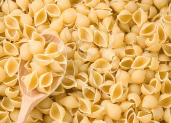 pasta and wooden spoon as background