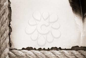 ship ropes and feather on old vintage ancient paper parchment background