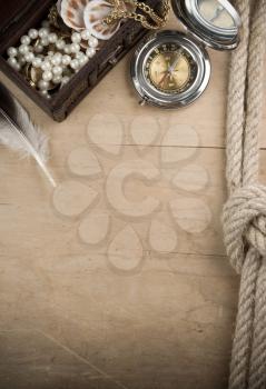 ship ropes and compass on wood background