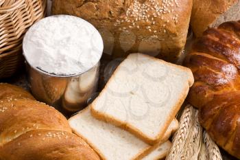 bread, spike, flour and basket on sacking