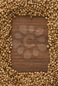 coriander spices on wood background