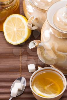 tea, pot and honey on table 