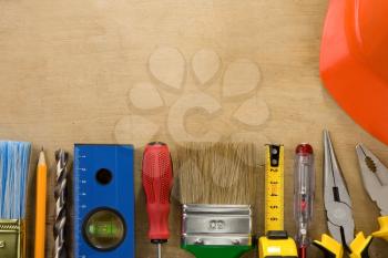 kit of construction tools and instruments on wood texture background