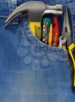 set of tools and instruments in blue jeans pocket