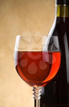 red wine in glass and bottle on wood background