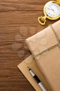 parcel wrapped with brown paper at wood background