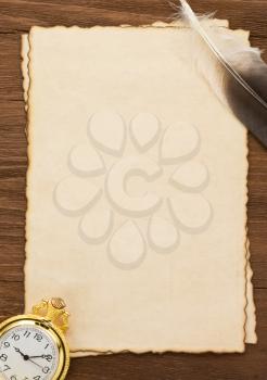 ink pen and watch on parchment background texture